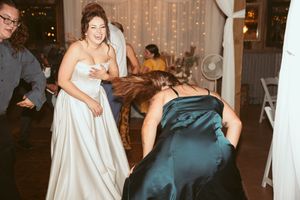 Wedding guests enjoying a celebration with twinkle lights glowing in an elegant venue setting.
