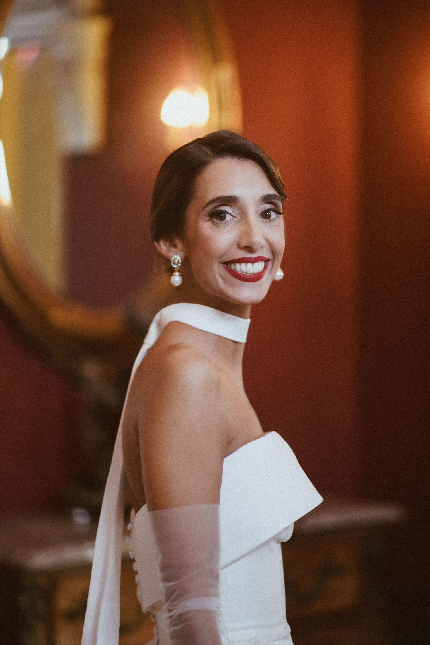 A bride in a classic white strapless gown smiles radiantly in a series of candid portrait shots.