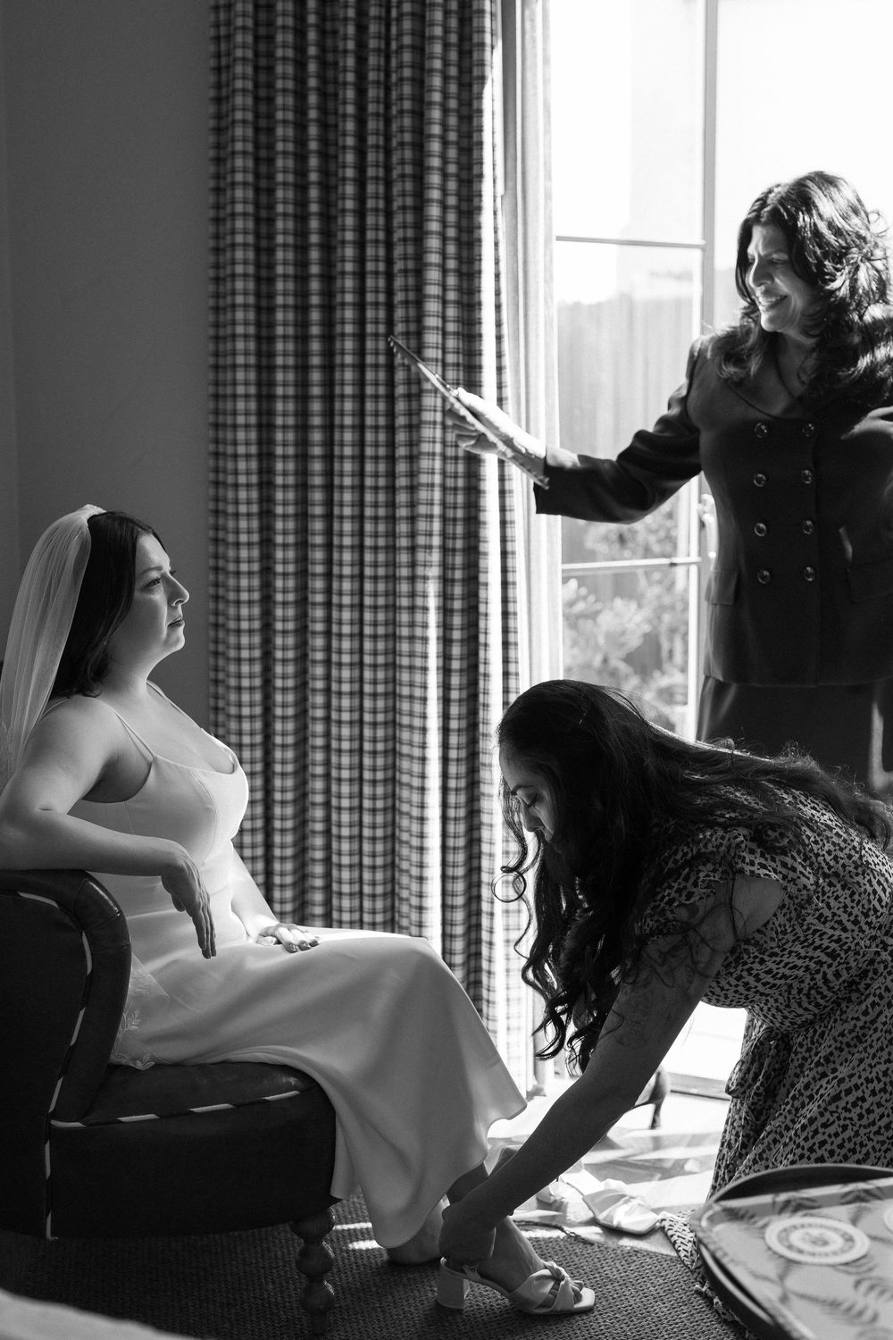 Bride's mom fans her daughter in a black and white photo