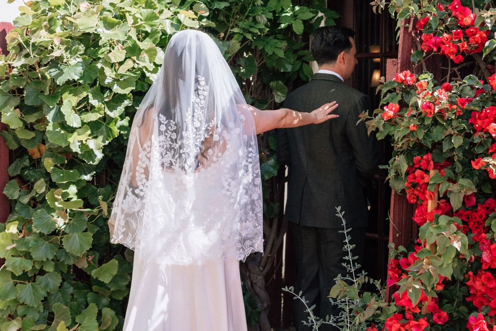 Bride taps groom so he can turn around and see her on wedding day