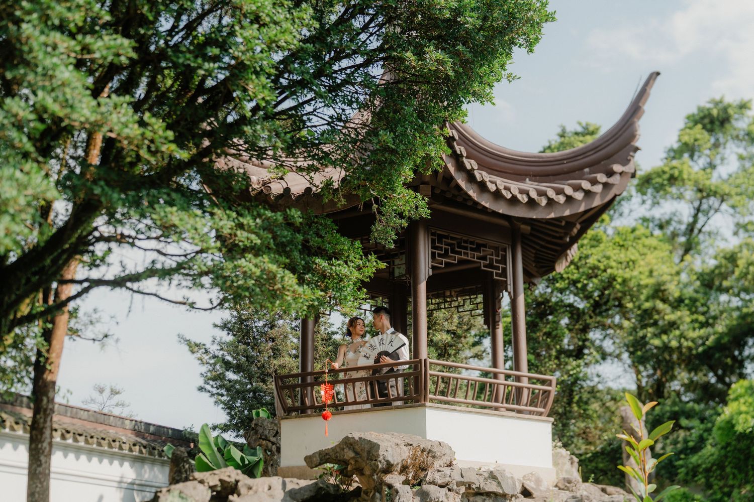 Traditional Chinese garden pavilions and architecture surrounded by lush greenery.