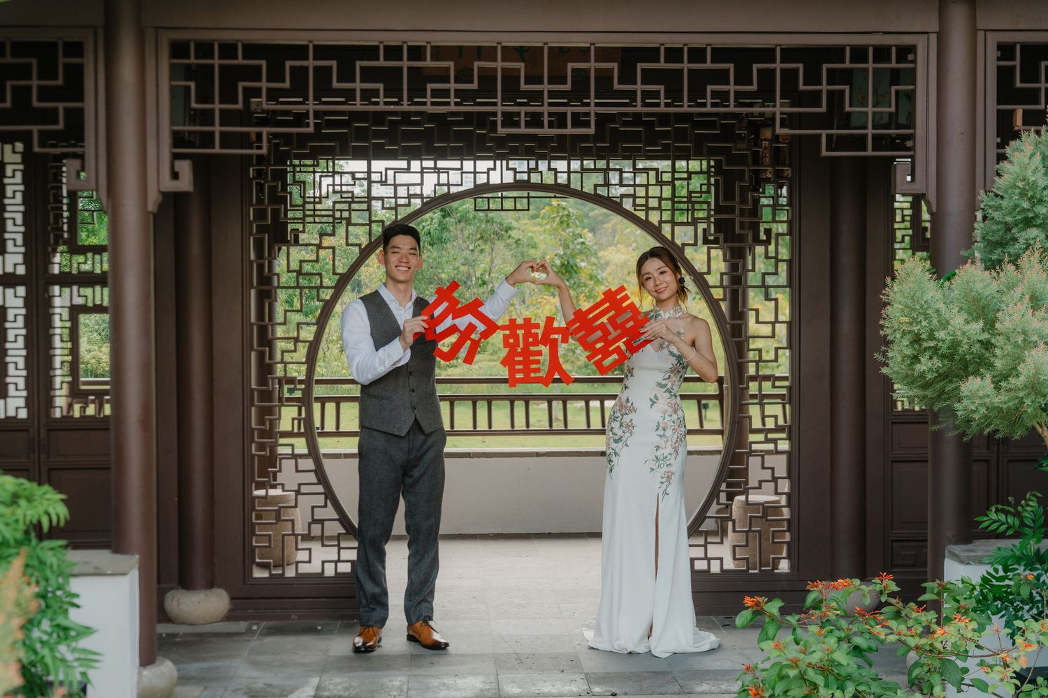 A romantic couple plays traditional Chinese mahjong together in a garden pavilion setting.