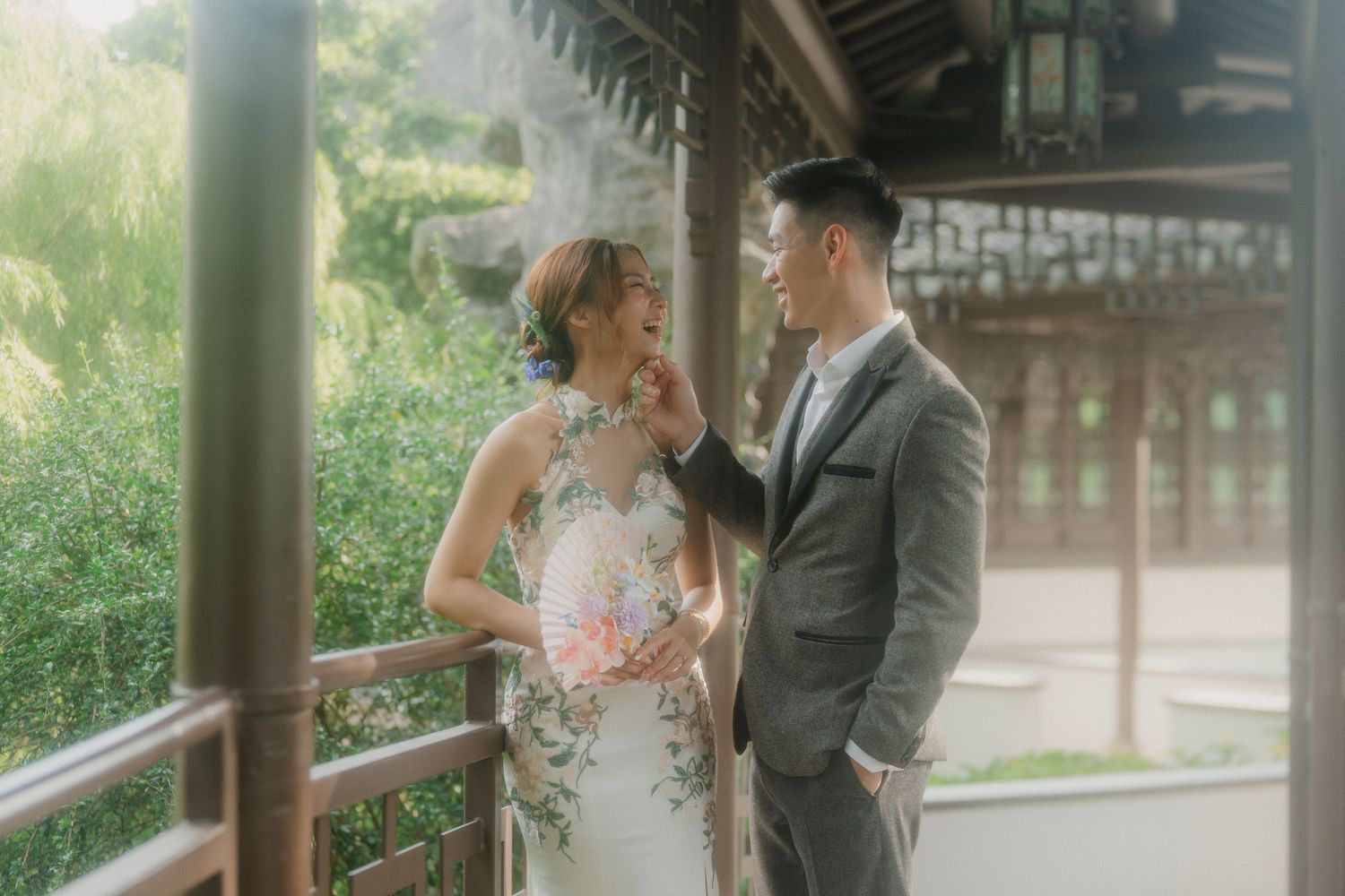 An intimate portrait of a couple sharing a romantic moment on a traditional covered porch with natural lighting.