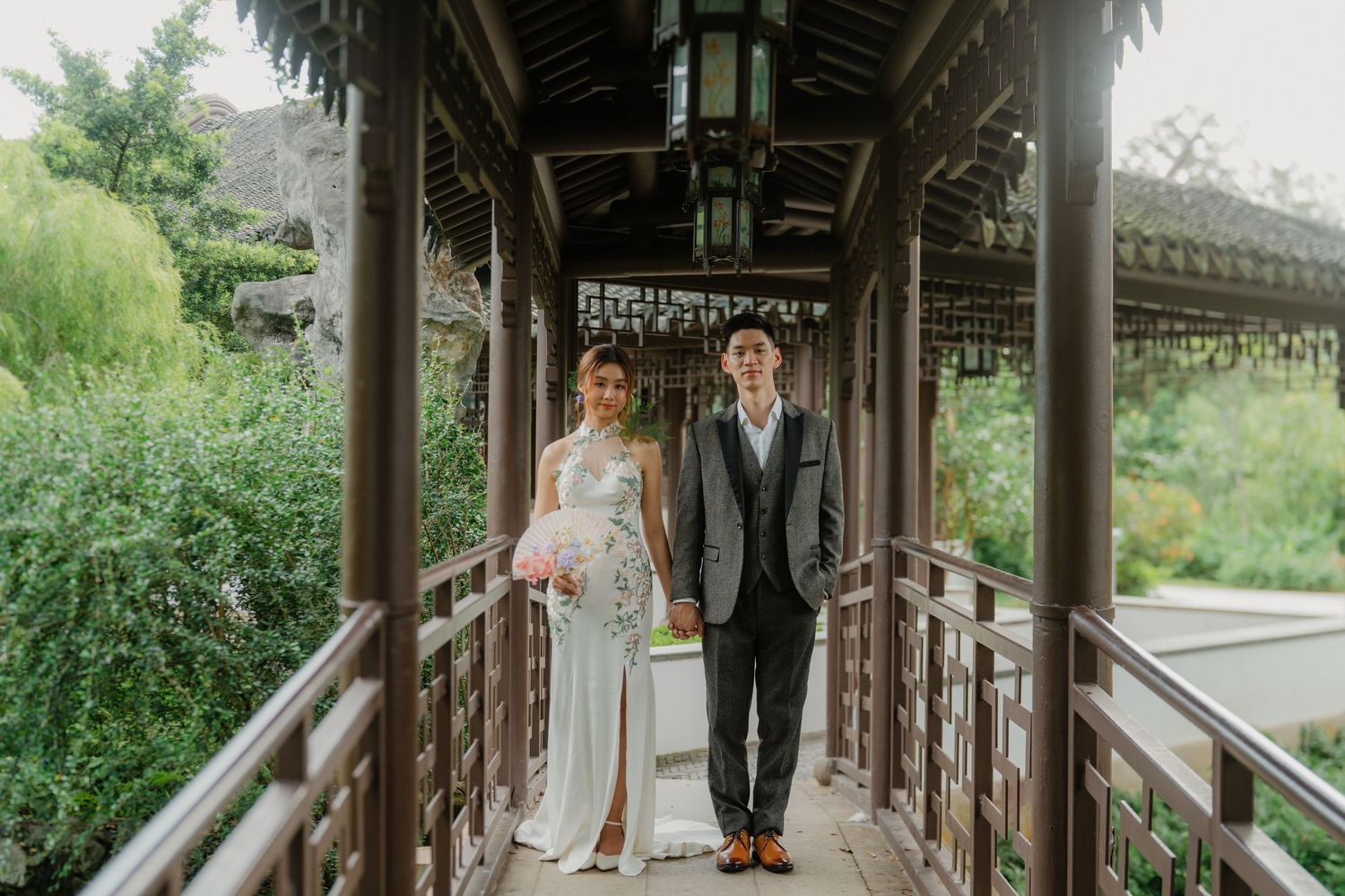 Wedding photography session in elegant Chinese garden corridor with traditional architecture.