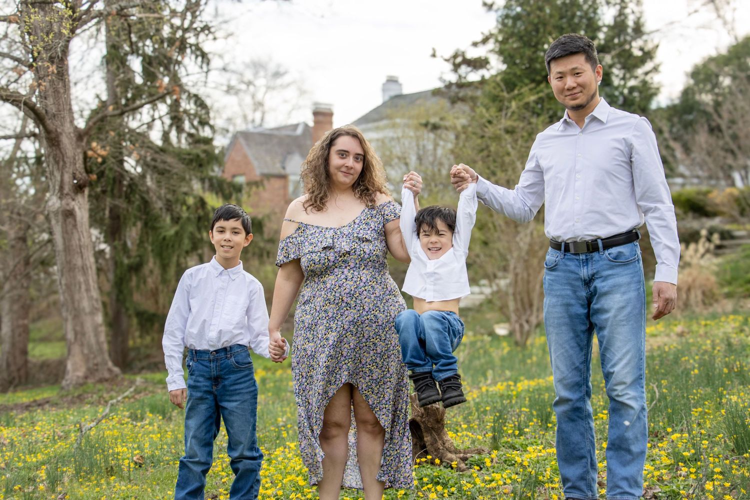 Ault Park Cincinnati Photographer captures family with sons candidly playing in a flower field during april. Affordable family photos quick