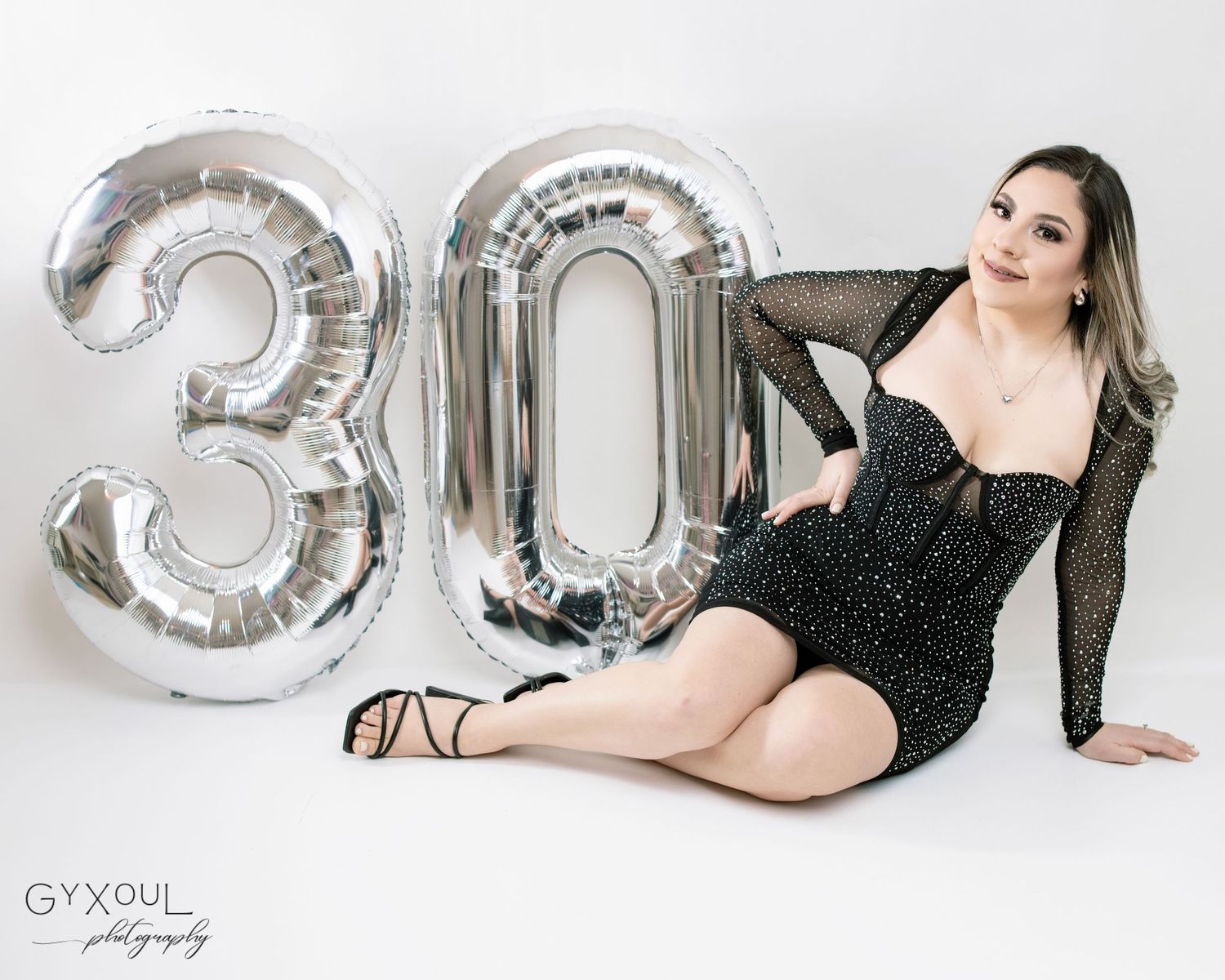 Elegant 30th birthday photoshoot while wearing sparkly black cocktail dress.