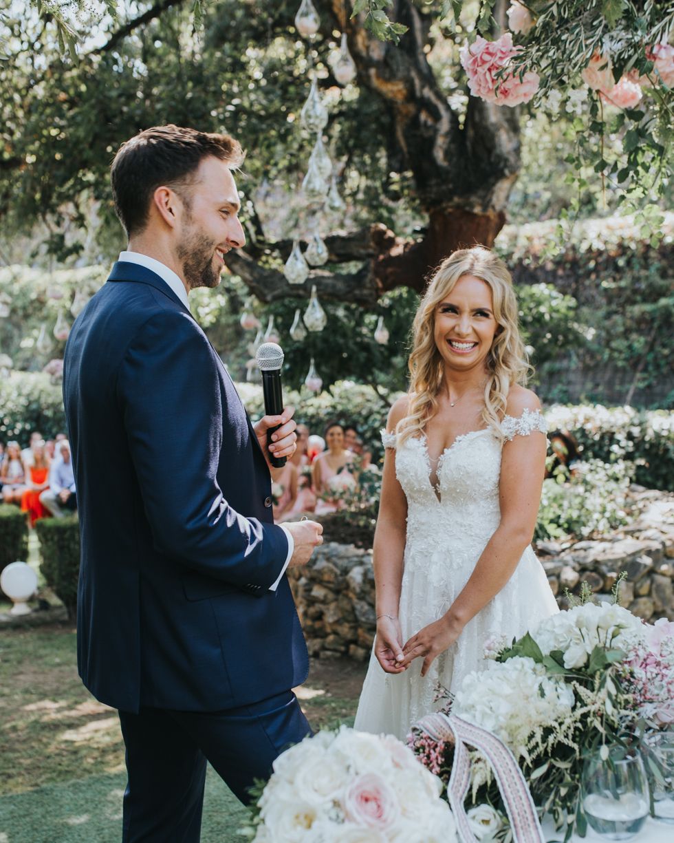 Beautiful outdoor garden wedding ceremony with white floral arrangements and natural decor.