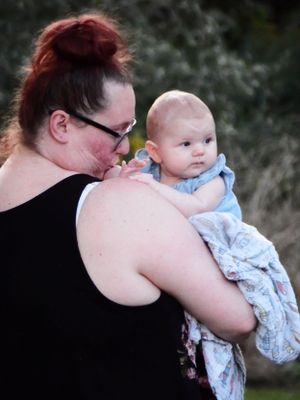 A tender moment between parent and child in soft evening light.