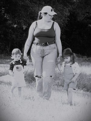 Black and white photos of people walking through a grassy field on a summer day.