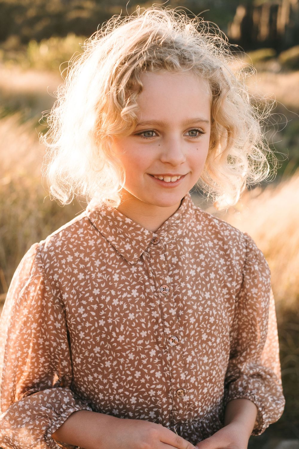 Portrait in golden hour light wearing a floral patterned shirt.