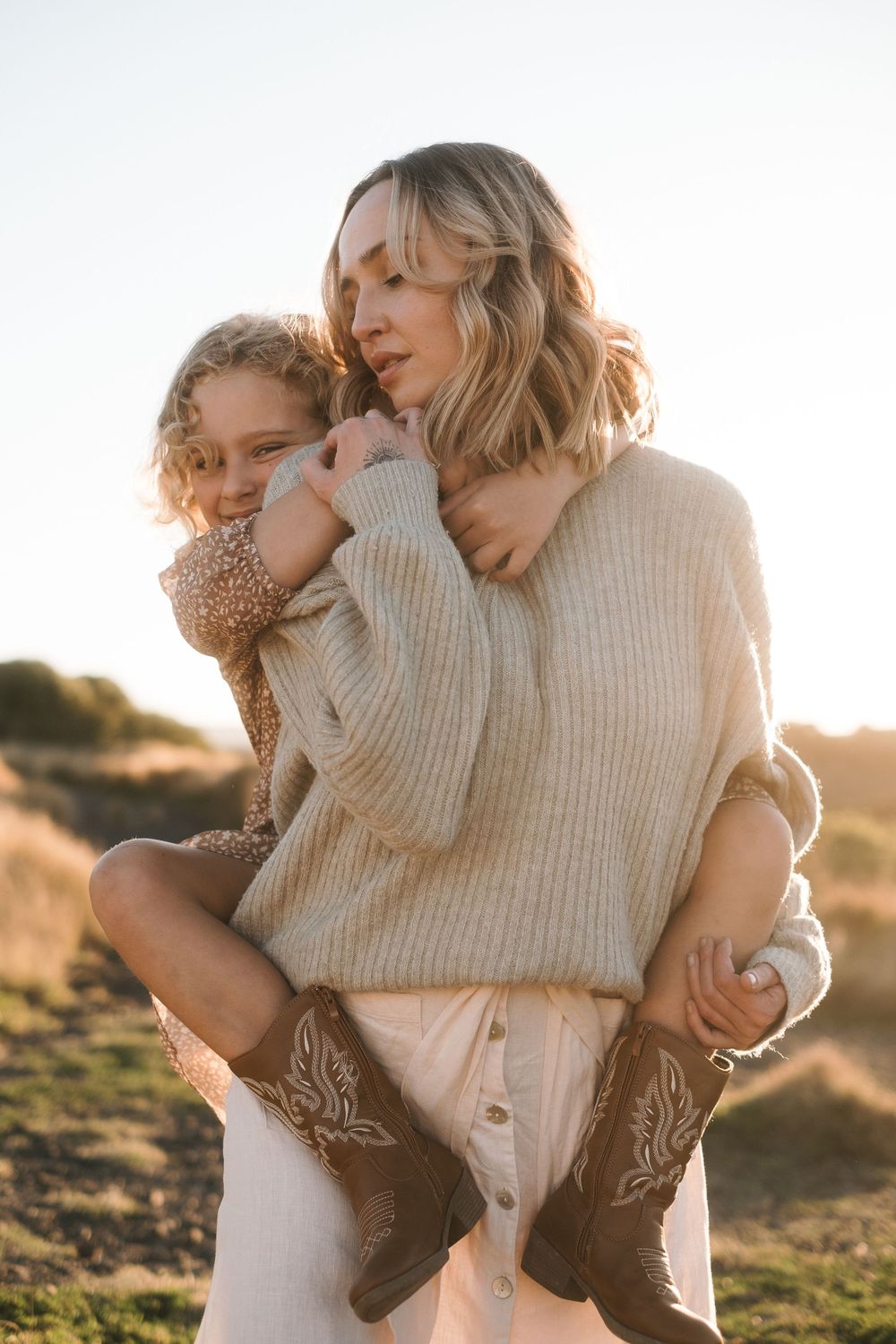 Cozy sunset portrait in warm knit sweaters against golden light.