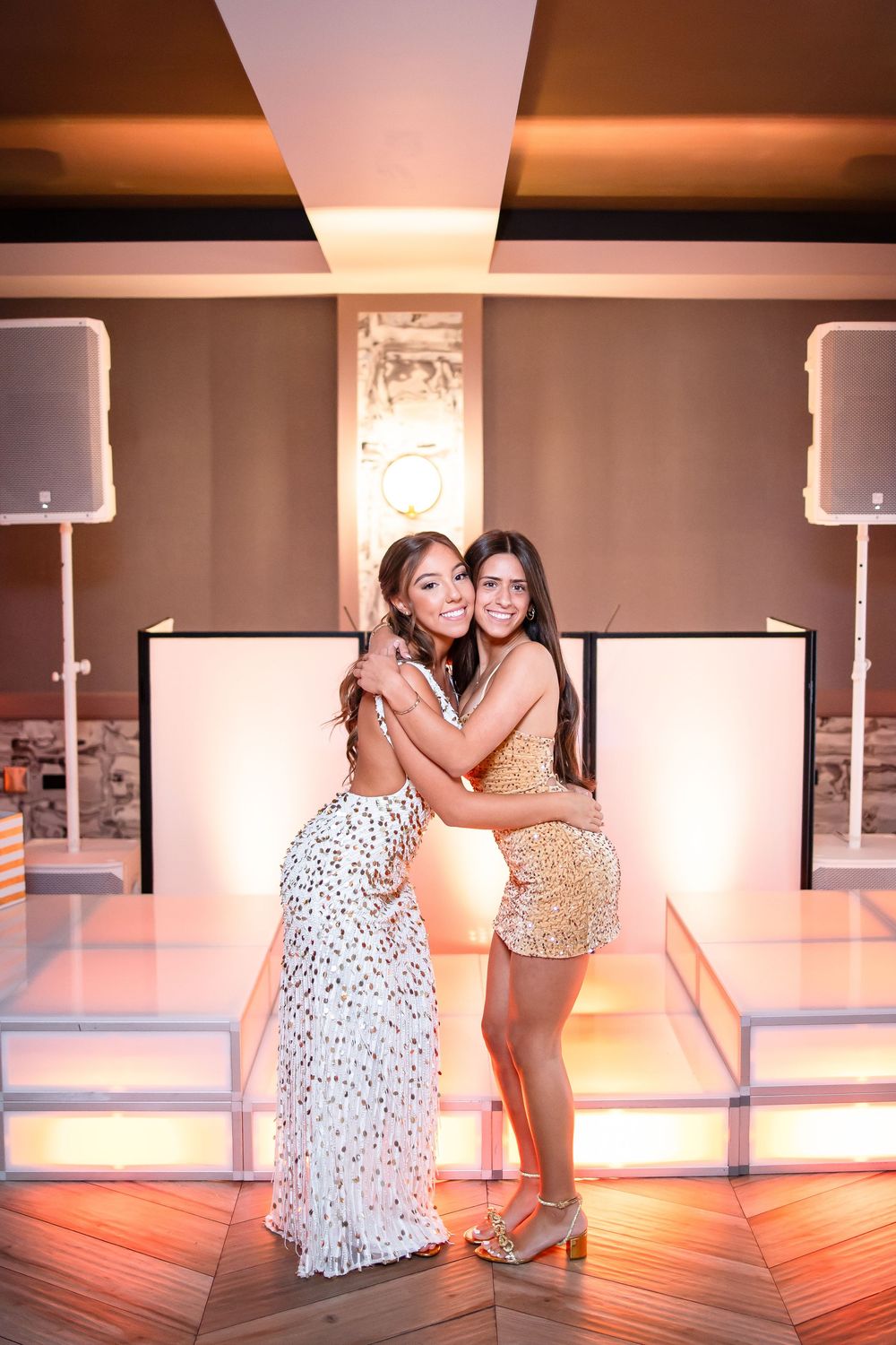 Two dancers in contrasting outfits perform an emotional duet in a warmly lit dance studio.