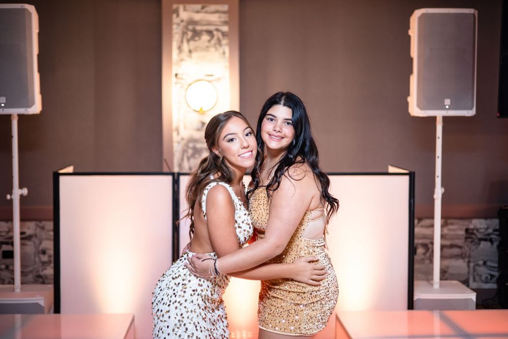 Two people in formal attire share an intimate moment while dancing at an event.