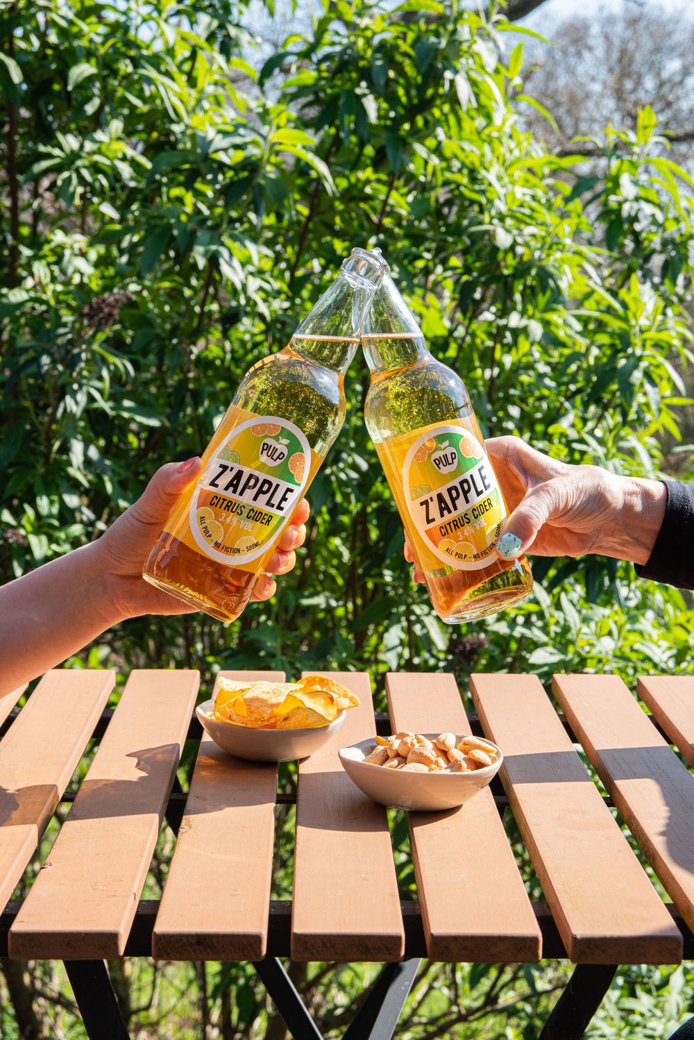 Food and drink photography of PULP Zapple citrus cider outdoors, by a Worcestershire-based photographer supporting small businesses.