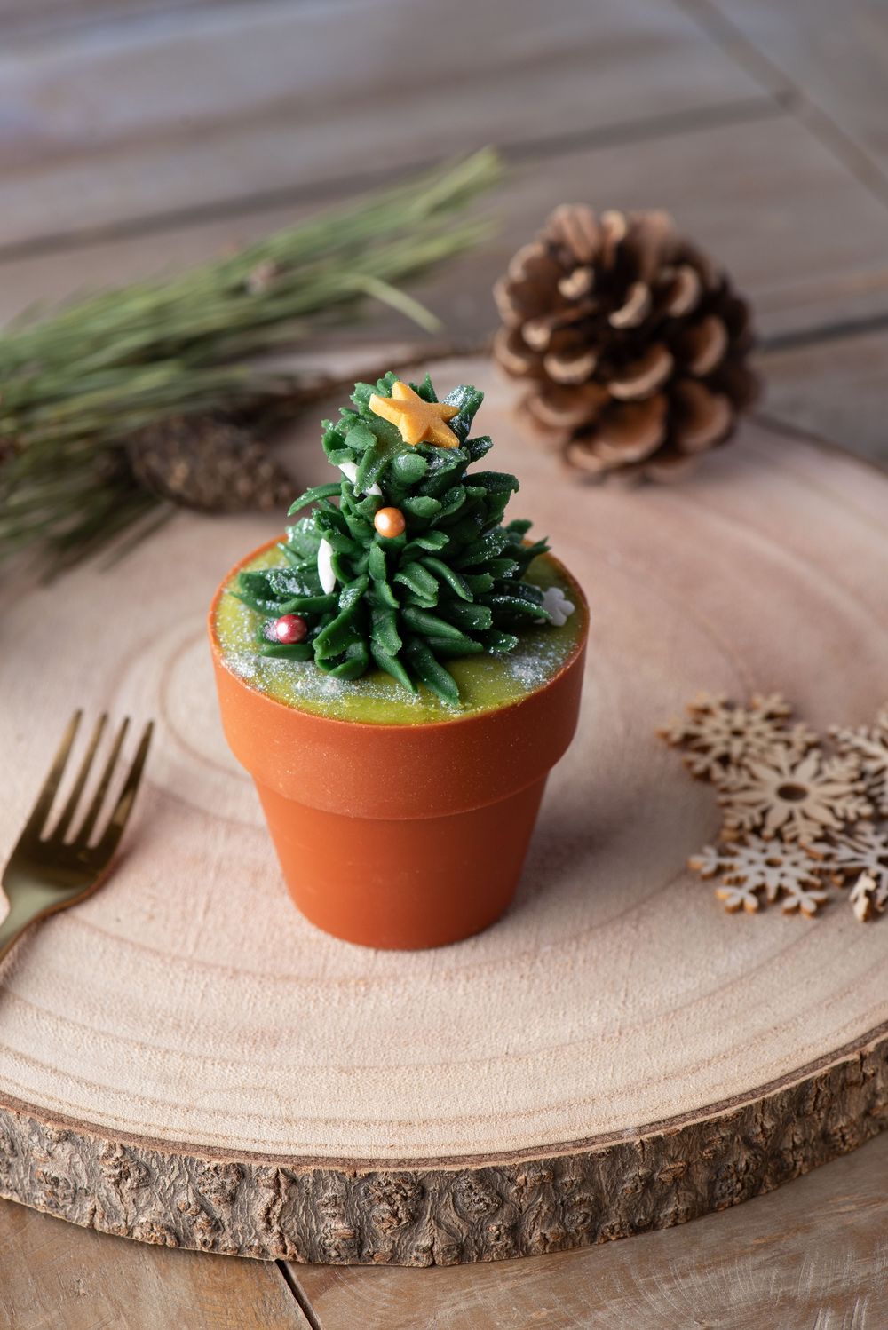 Creative cupcake photography styled as a Christmas tree in a plant pot, with festive details, captured by a Worcestershire food photographer