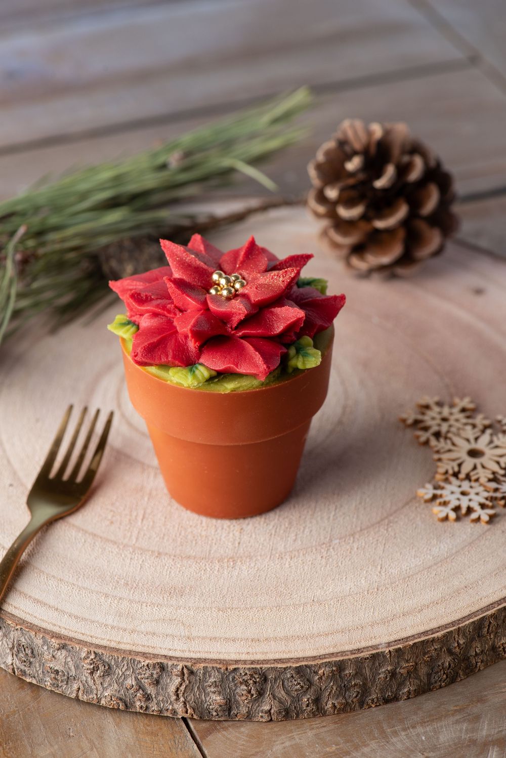 Festive cupcake photography styled as a poinsettia flower in a pot, captured by a Worcestershire food photographer for small baking business
