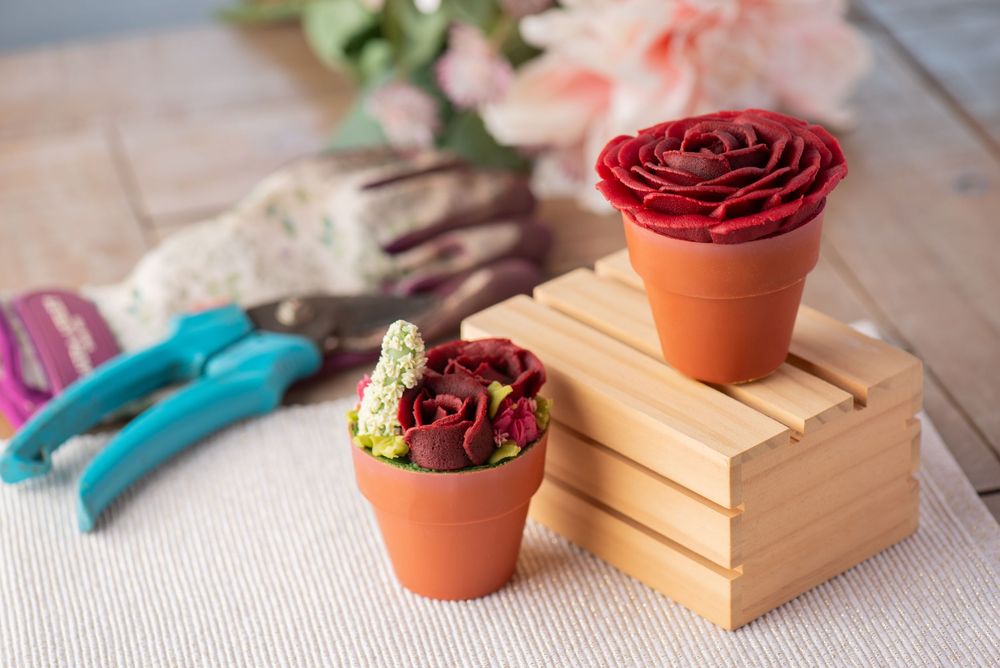 Creative food photography of floral cupcakes styled as potted plants with gardening props, captured by a Worcestershire food photographer