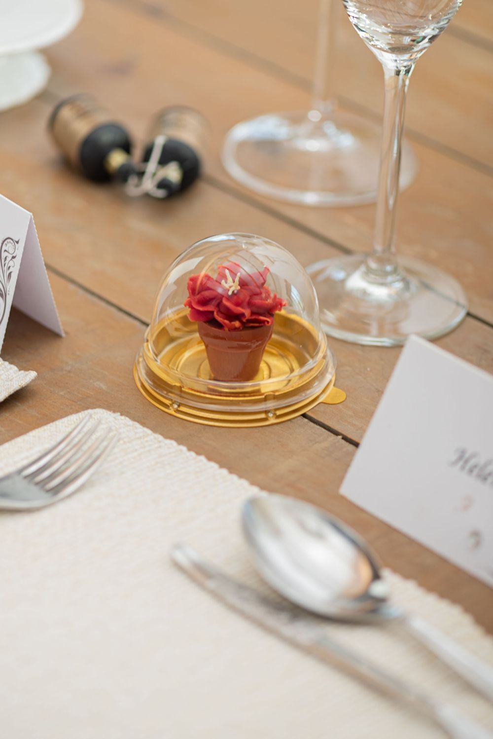 Elegant cupcake favour styled as a flower in a dome, photographed by a Worcestershire-based food photographer for artisan brands.