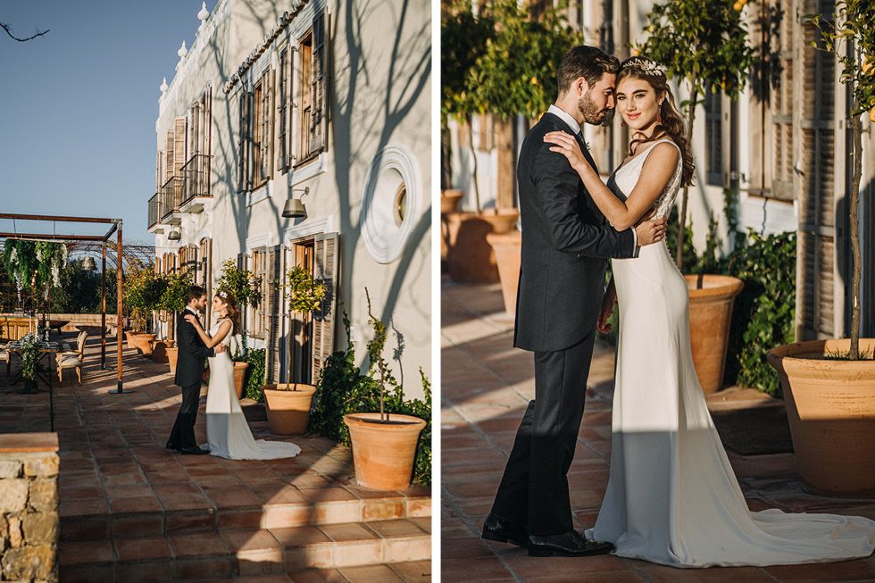 A couple shares an intimate moment during a late afternoon wedding ceremony on an elegant outdoor terrace.