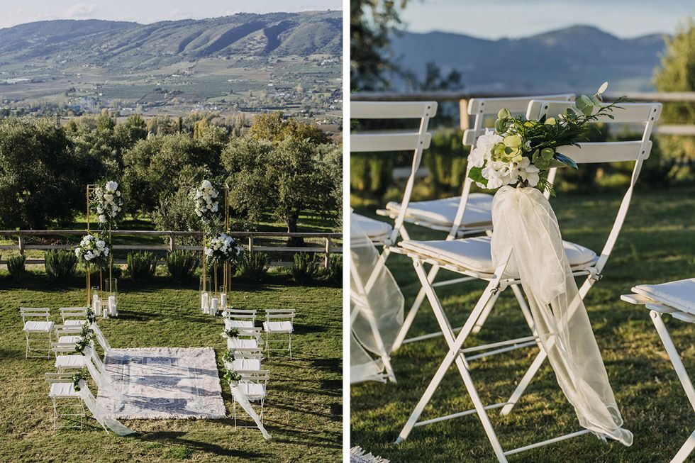 Rustic outdoor wedding ceremony setup with white folding chairs and flowy fabric decor in mountain landscape setting.