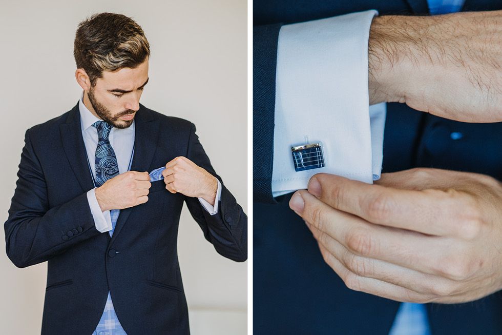 Close-up details of formal attire showing navy suit jacket and decorative cufflinks.