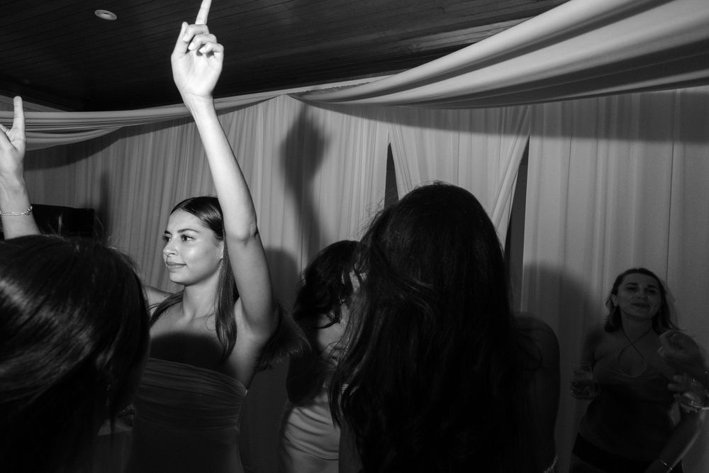 Silhouettes of people dancing and celebrating at a party.