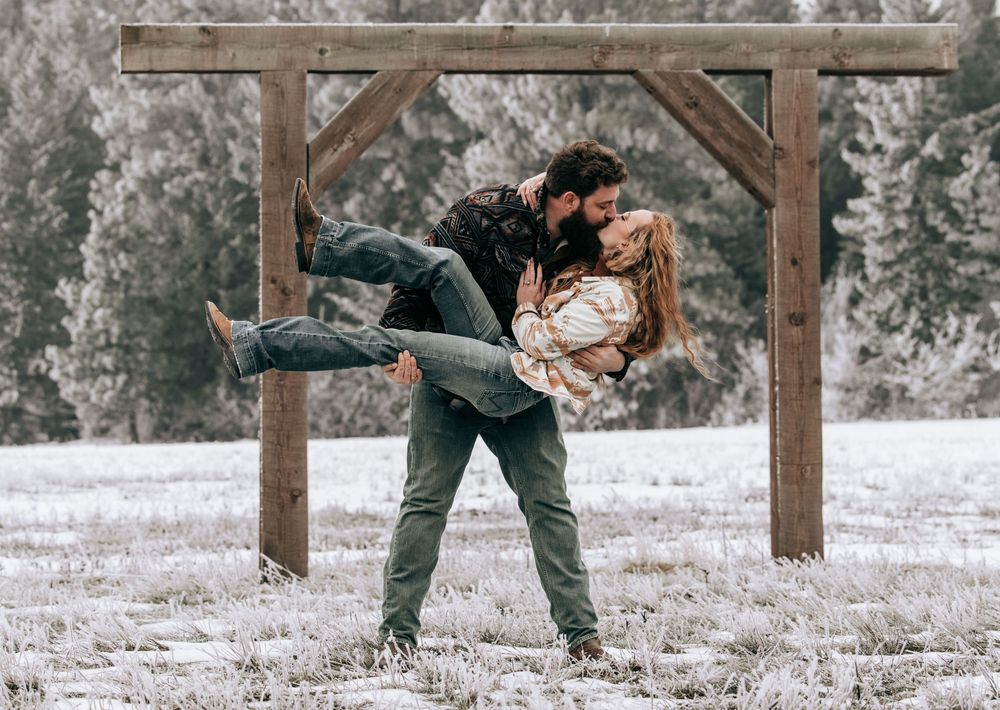 Cle Elum, WA Engagement session couple kissing as man holds woman in winter scene.