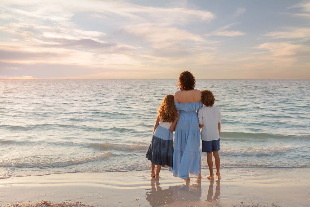 Waves gently roll onto the shore during a peaceful sunset at the beach.
