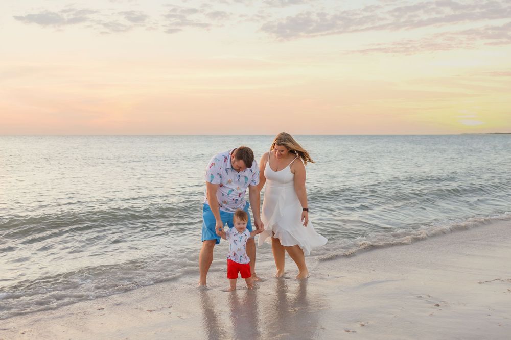 A peaceful beach scene at sunset with gentle waves rolling onto the shore.