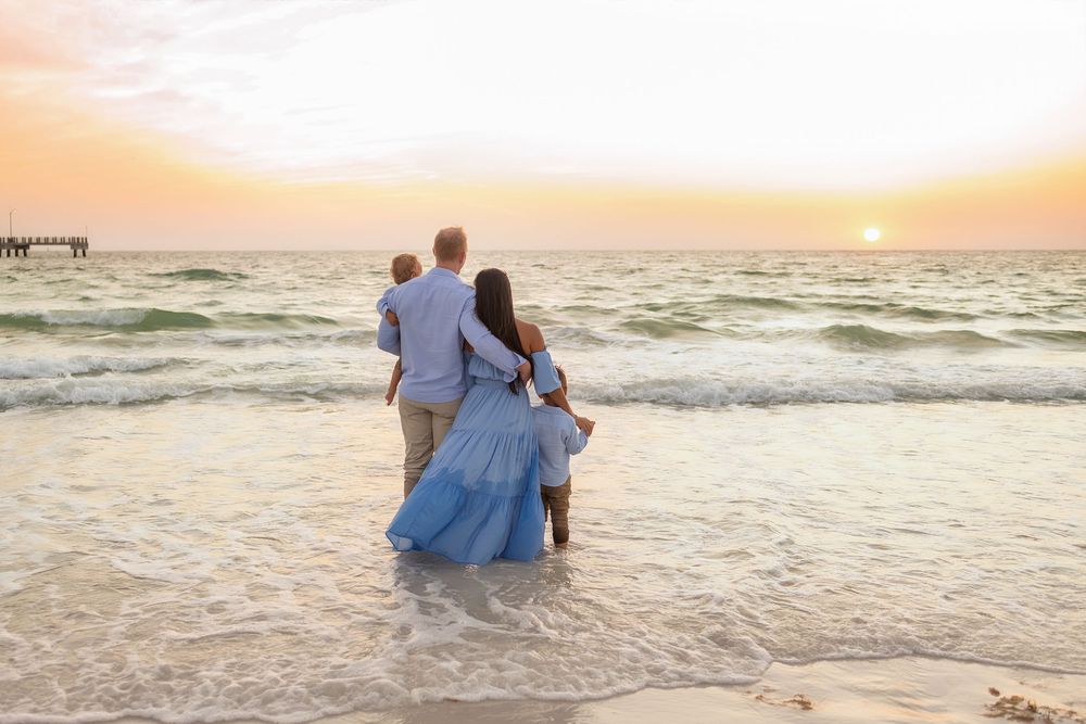 Romantic sunset beach photos with couple walking along shoreline.