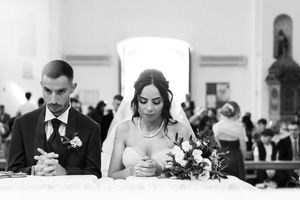 A series of black and white wedding photos showing intimate moments during a ceremony and reception.