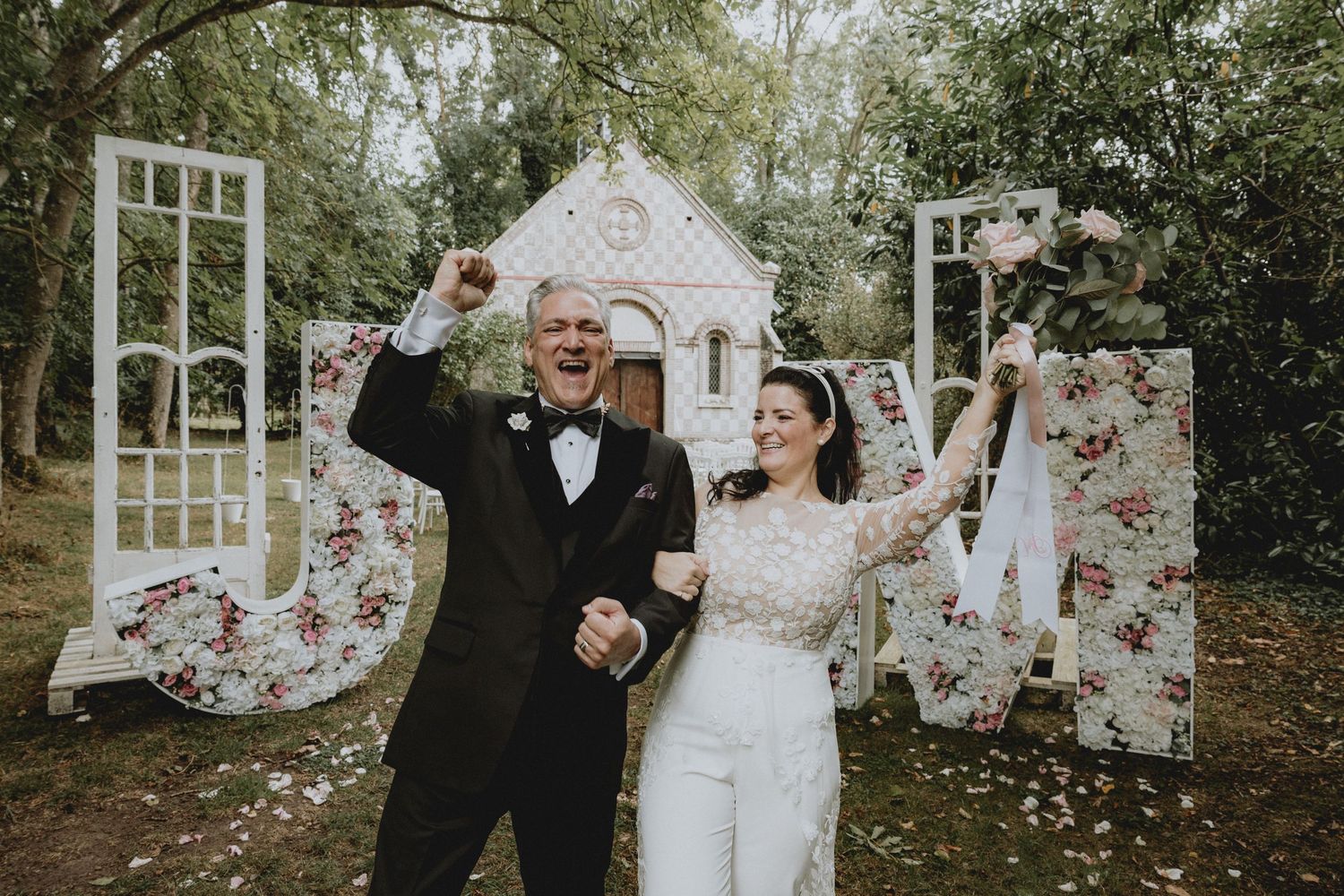 Destination wedding in France, Normandy. Chateau de Garembourg. Bride and groom celebrating and laughing