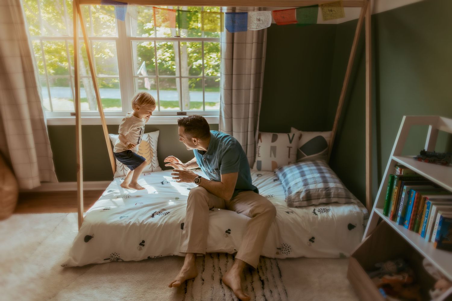 Cozy bedroom scene with natural light streaming through windows onto a bed with polka dot bedding.