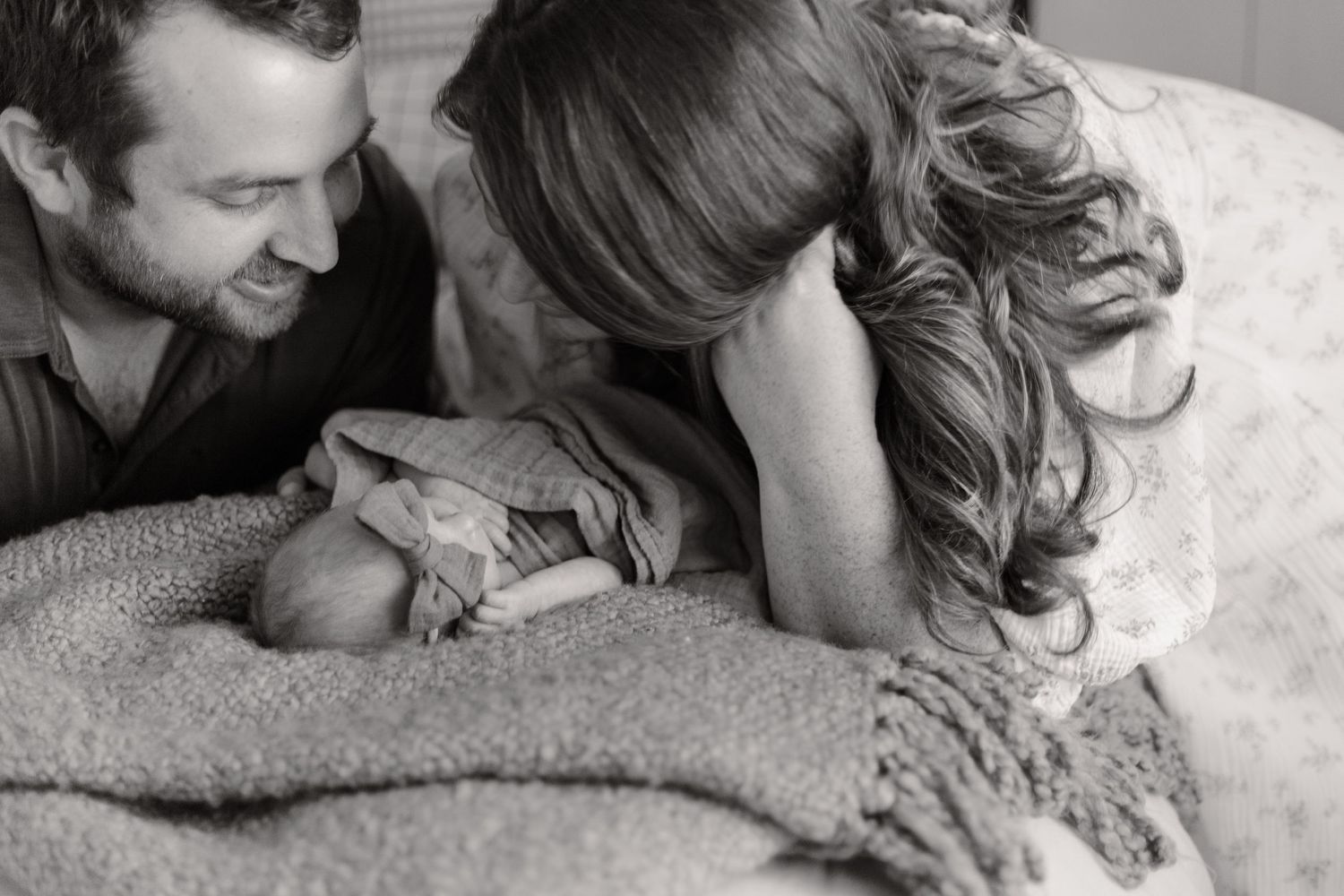 A black and white photo series showing a baby's expressions ranging from calm to crying.