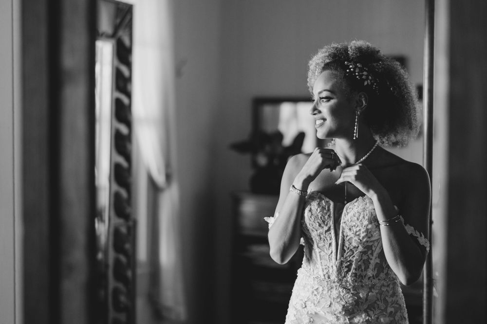 A black and white wedding photo collage showing a bride in different poses and moments during her special day.