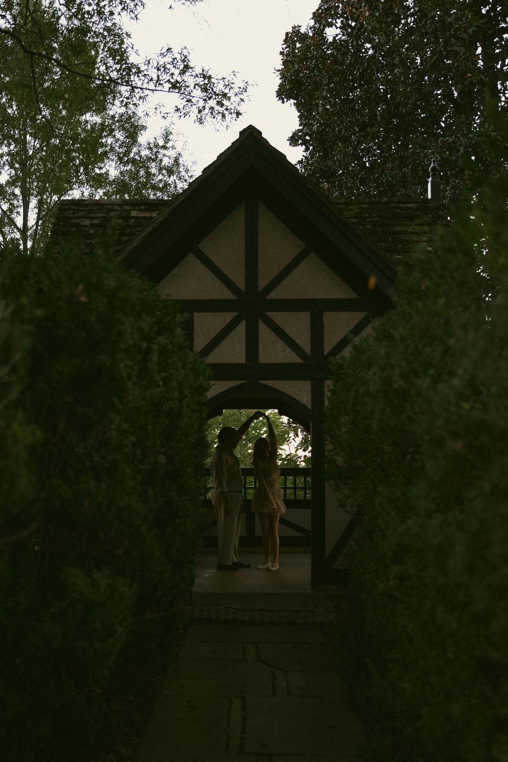 Tudor-style architecture with dark wooden beams against a twilight sky.