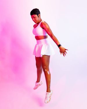 Athlete in pink and white sportswear performs dynamic jump sequence against pink and white gradient background.
