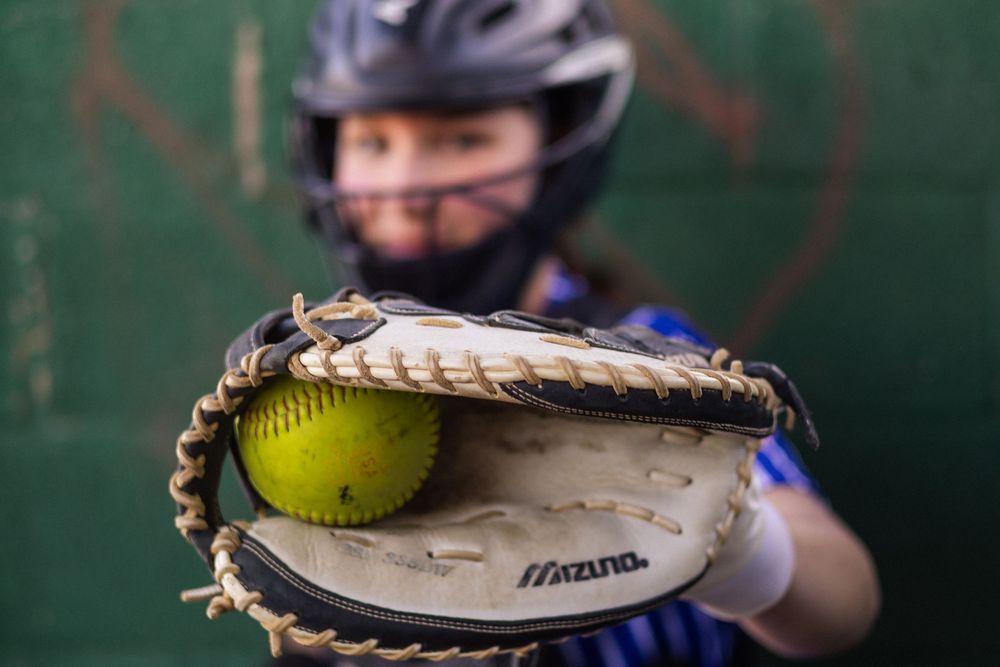 Softball glove and catching motion sequence shown against a dark green background.
