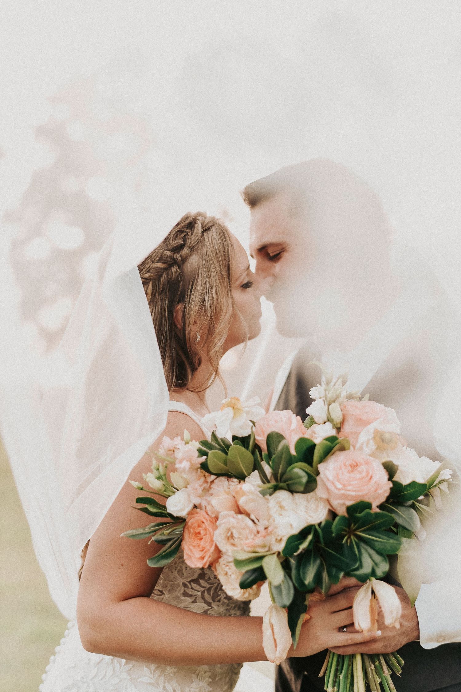 Intimate candid moment between bride and groom during their spring wedding day.