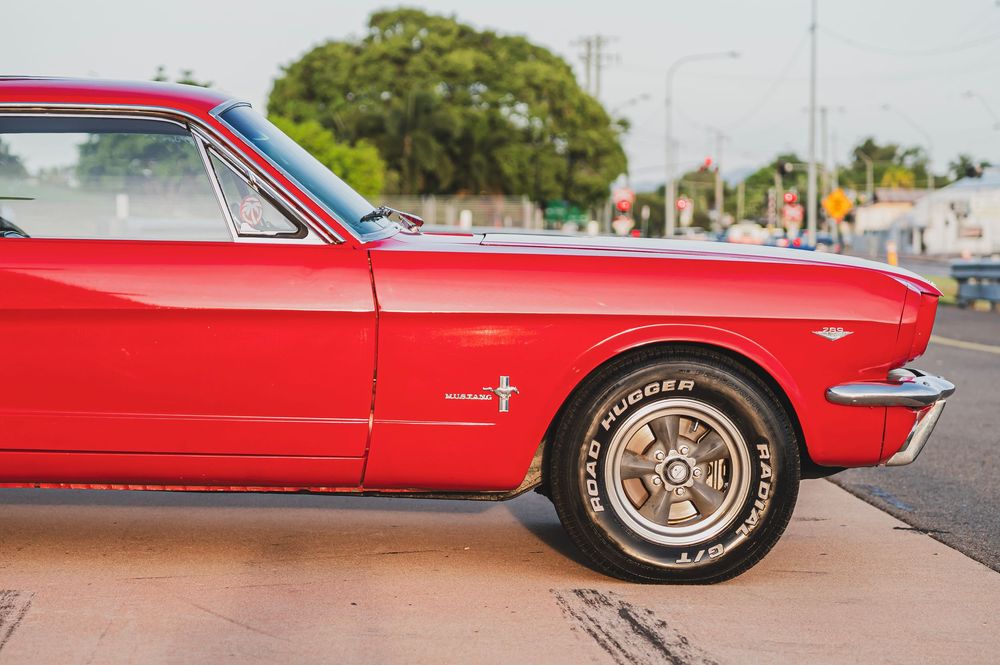 A series of six red vintage Ford Thunderbird cars lined up showing different angles and details of the classic automobile.