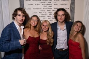 A series of photo booth style snapshots showing couples in formal attire with red dresses at what appears to be a party.