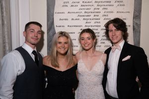 Group of people in formal attire posing together at an event in black and white and color photos.
