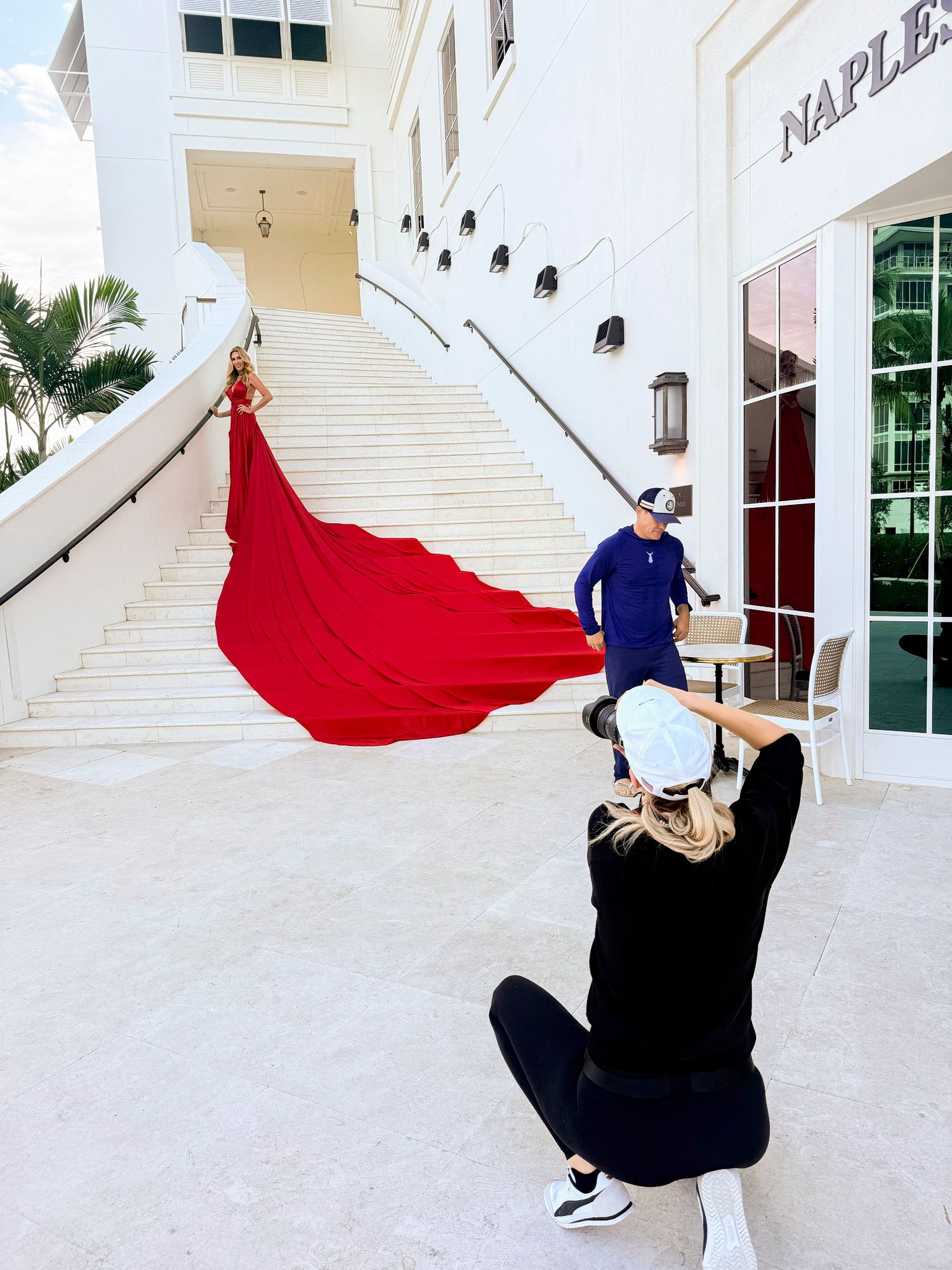 A sequence of dance movements showing a flowing red cape against a white architectural backdrop with dramatic spins and poses.