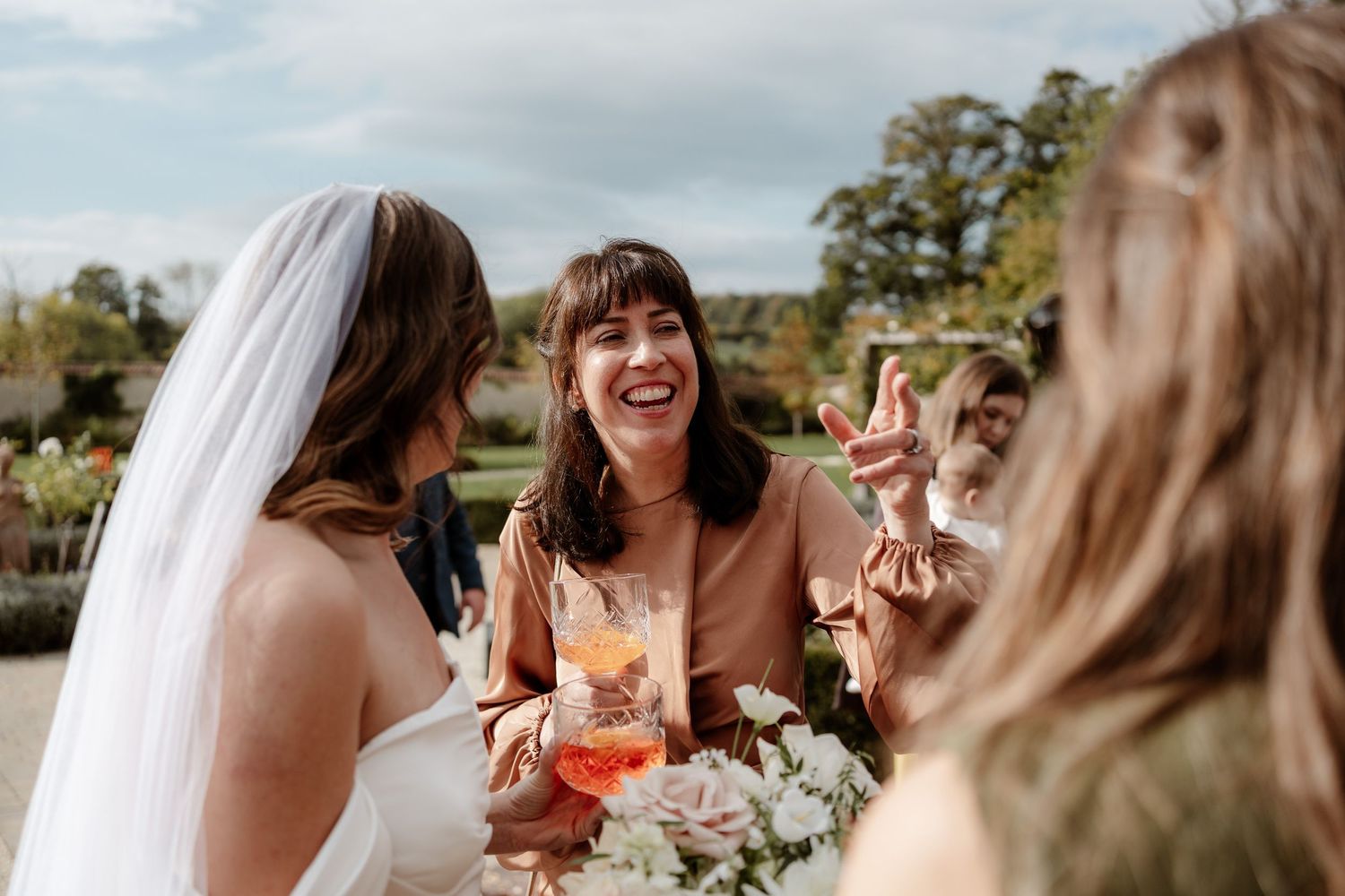 A joyful wedding celebration with candid moments captured in a series of outdoor photos showing laughter and celebration.