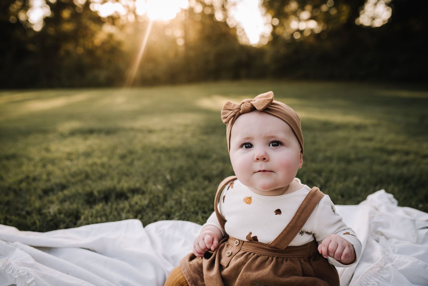 A collection of outdoor sunset portraits showing a baby in brown clothing against a natural background. Family photographer in Middle Tennes