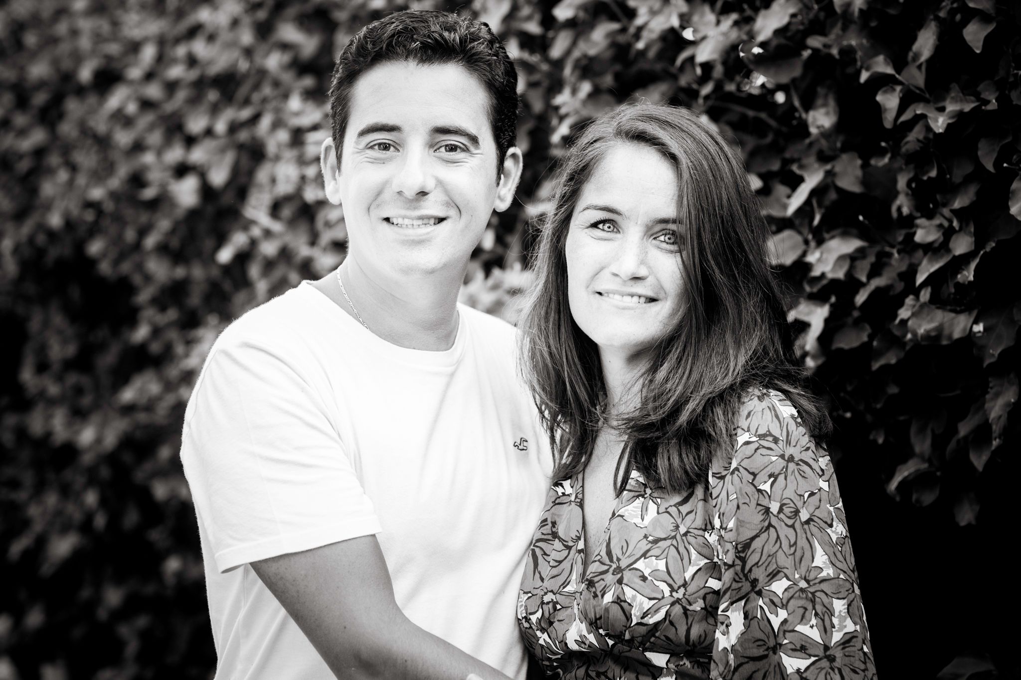 A black-and-white photo of a couple looking at the camera in a villa in Marbella.