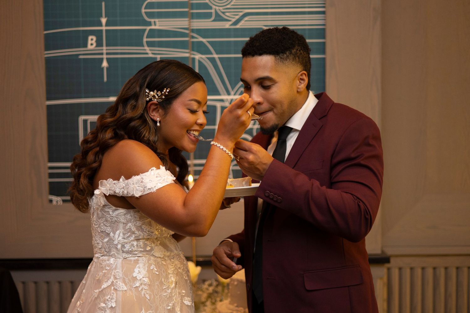 A couple in wedding attire share a romantic dance moment in an elegant indoor venue.