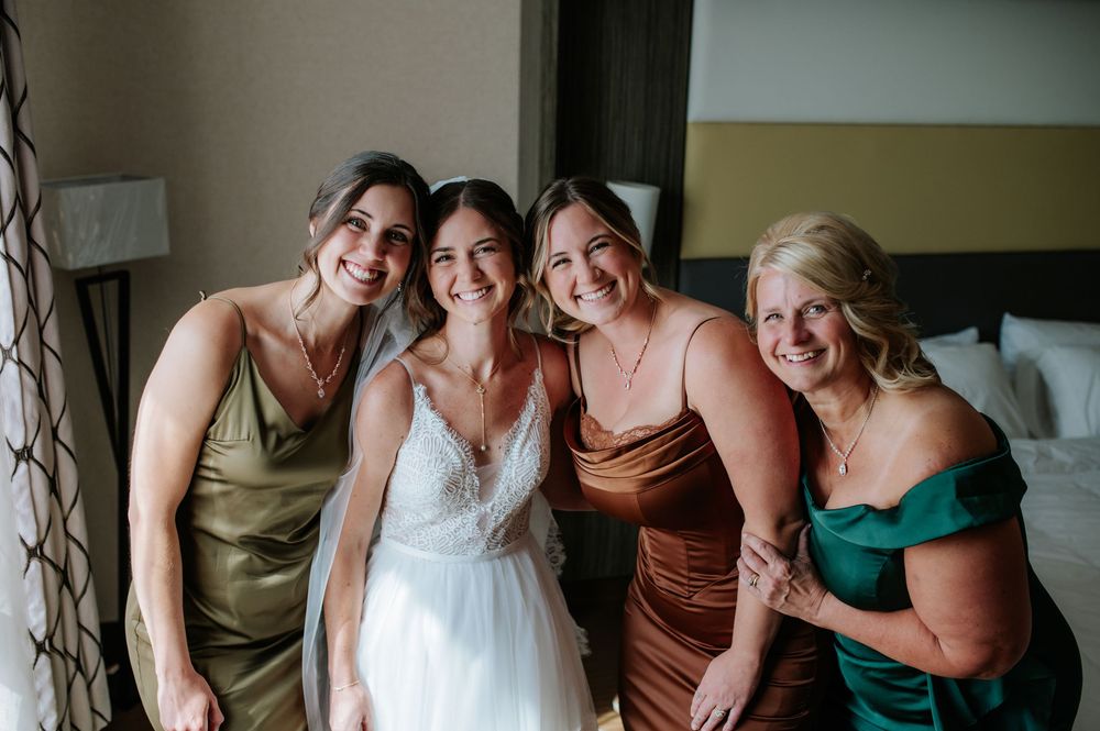 Wedding party members sharing joyful moments before the ceremony.