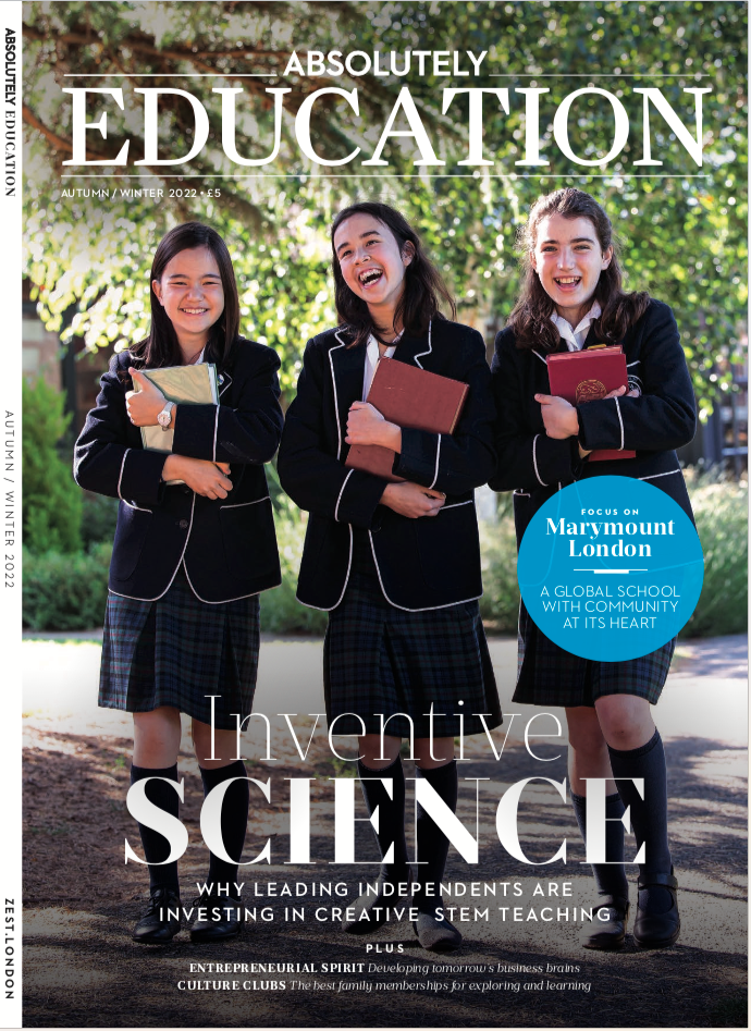 Three students in school uniforms holding books and smiling on a magazine cover titled 'Absolutely Education'.