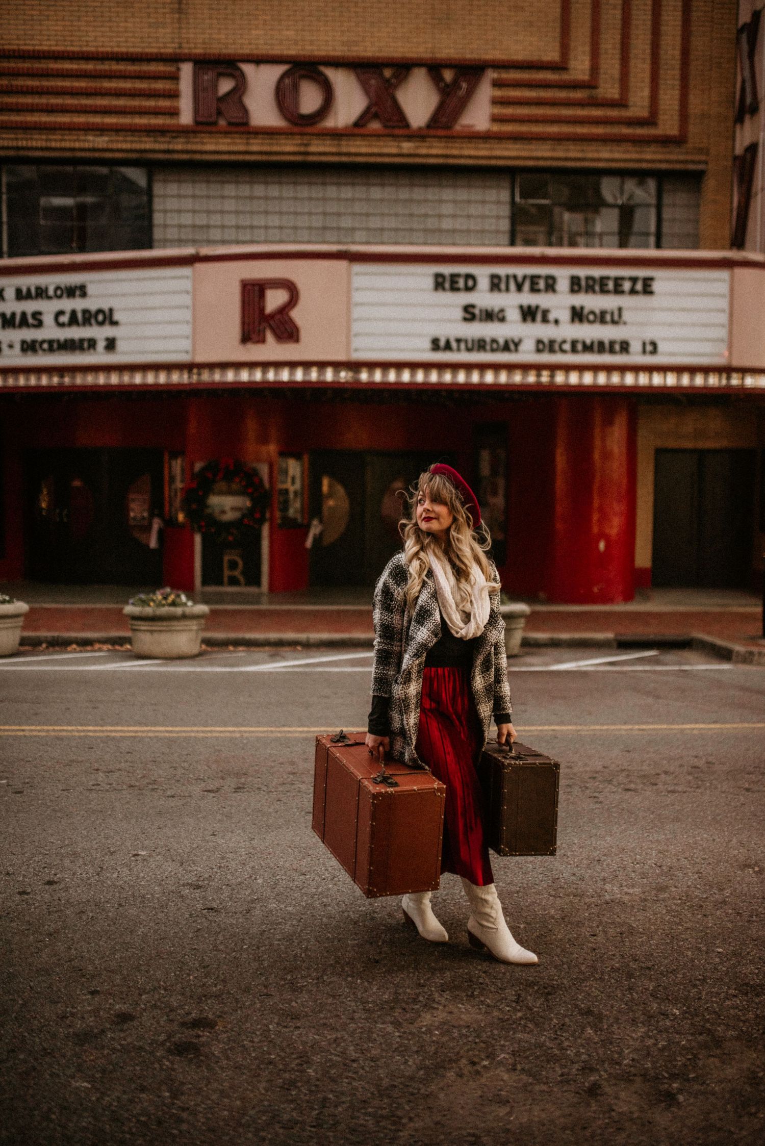 Classy portrait of a woman in 1940s attire in front of the vintage looking Roxy movie theather in Downtown Clarksville, Tennessee.